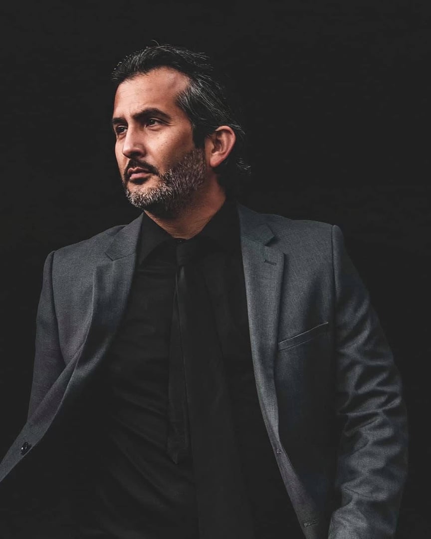 Professional photographer and beautiful model on fashion shoot in photo studio with lighting equipment. Occupation concept