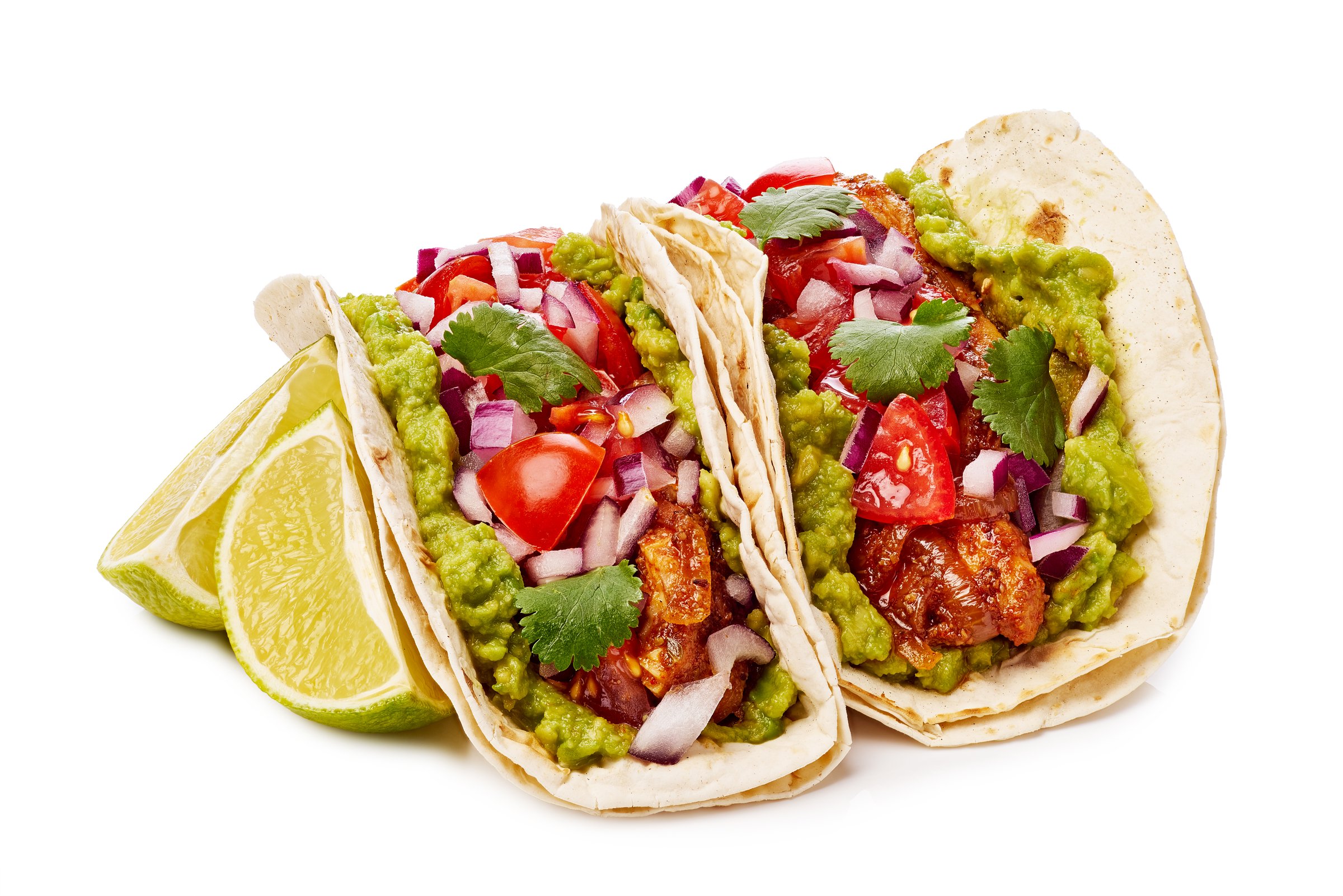 Delicious tacos filled with fresh guacamole, diced tomatoes, chopped onions, and garnished with a lime slice