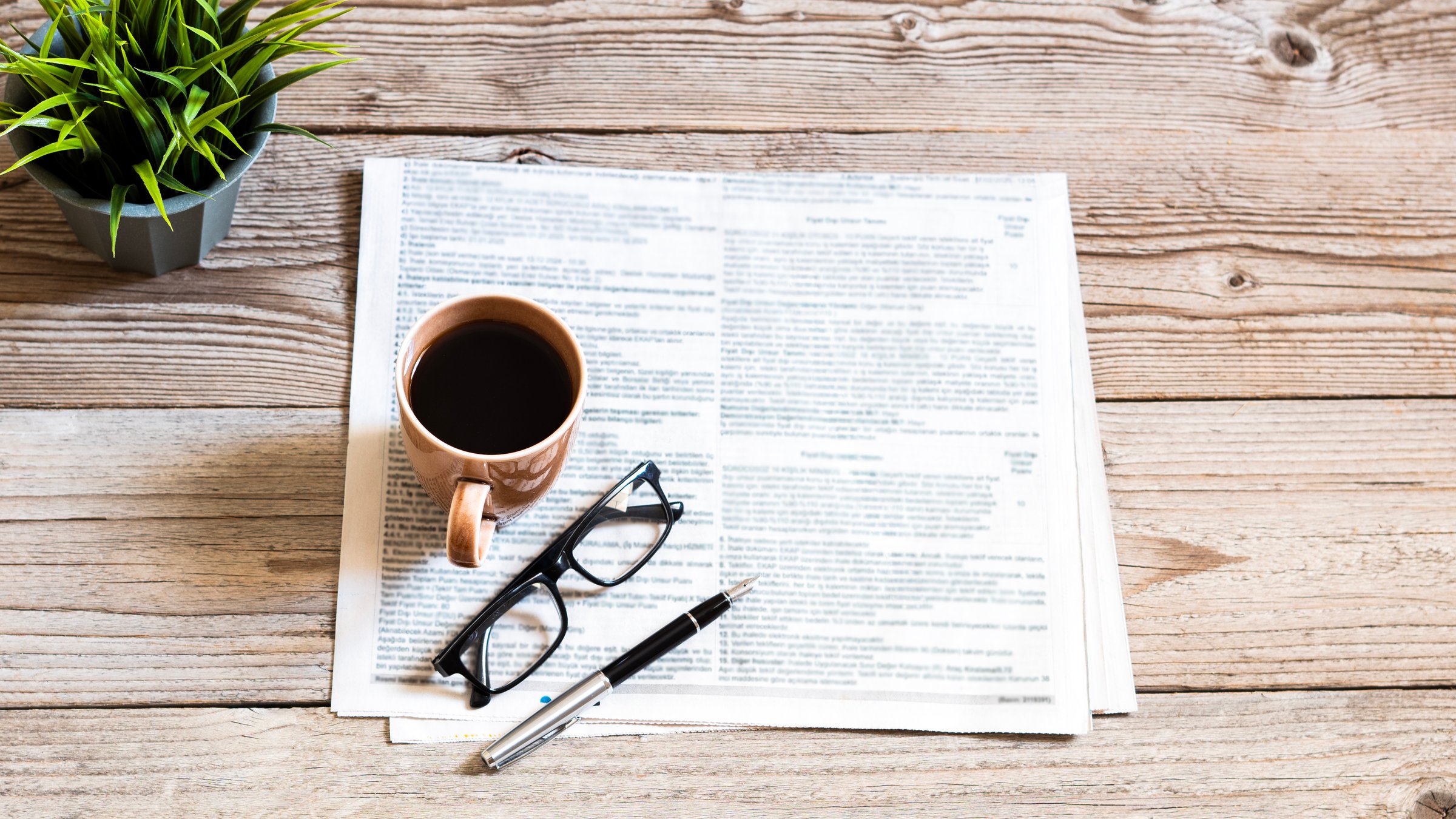 Blurred newspaper on wood table