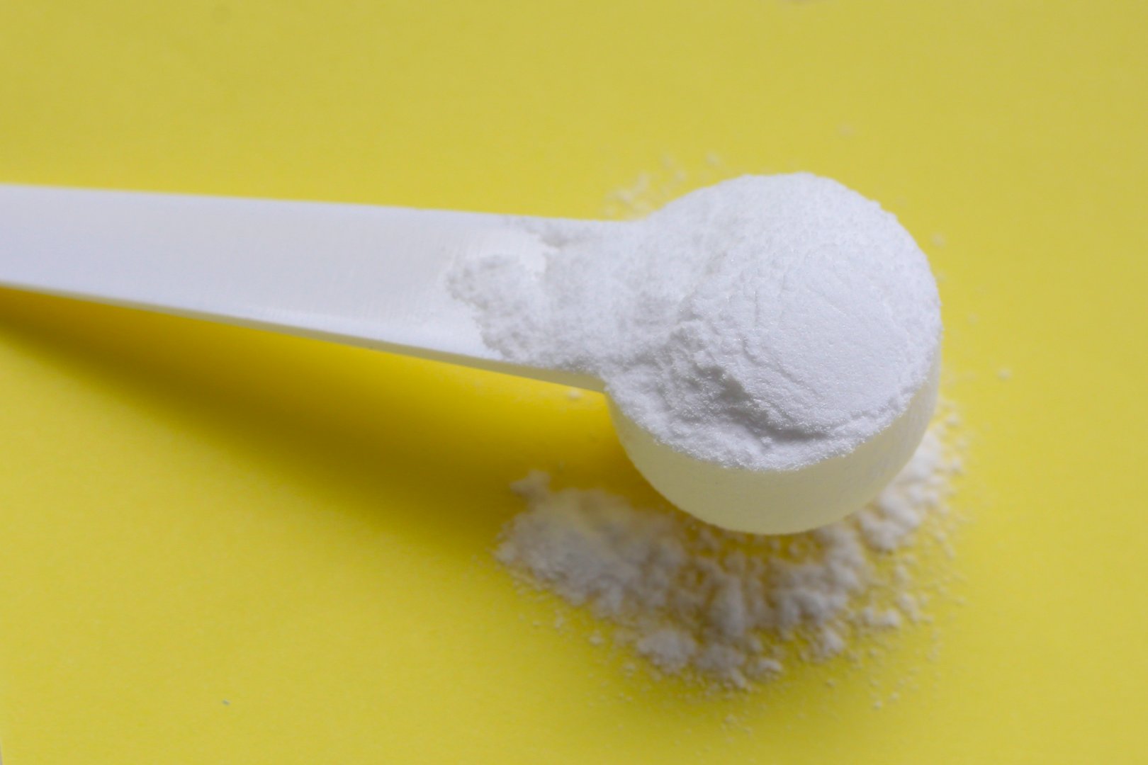 White creatine powder, used as a pre-workout supplement for gym and fitness