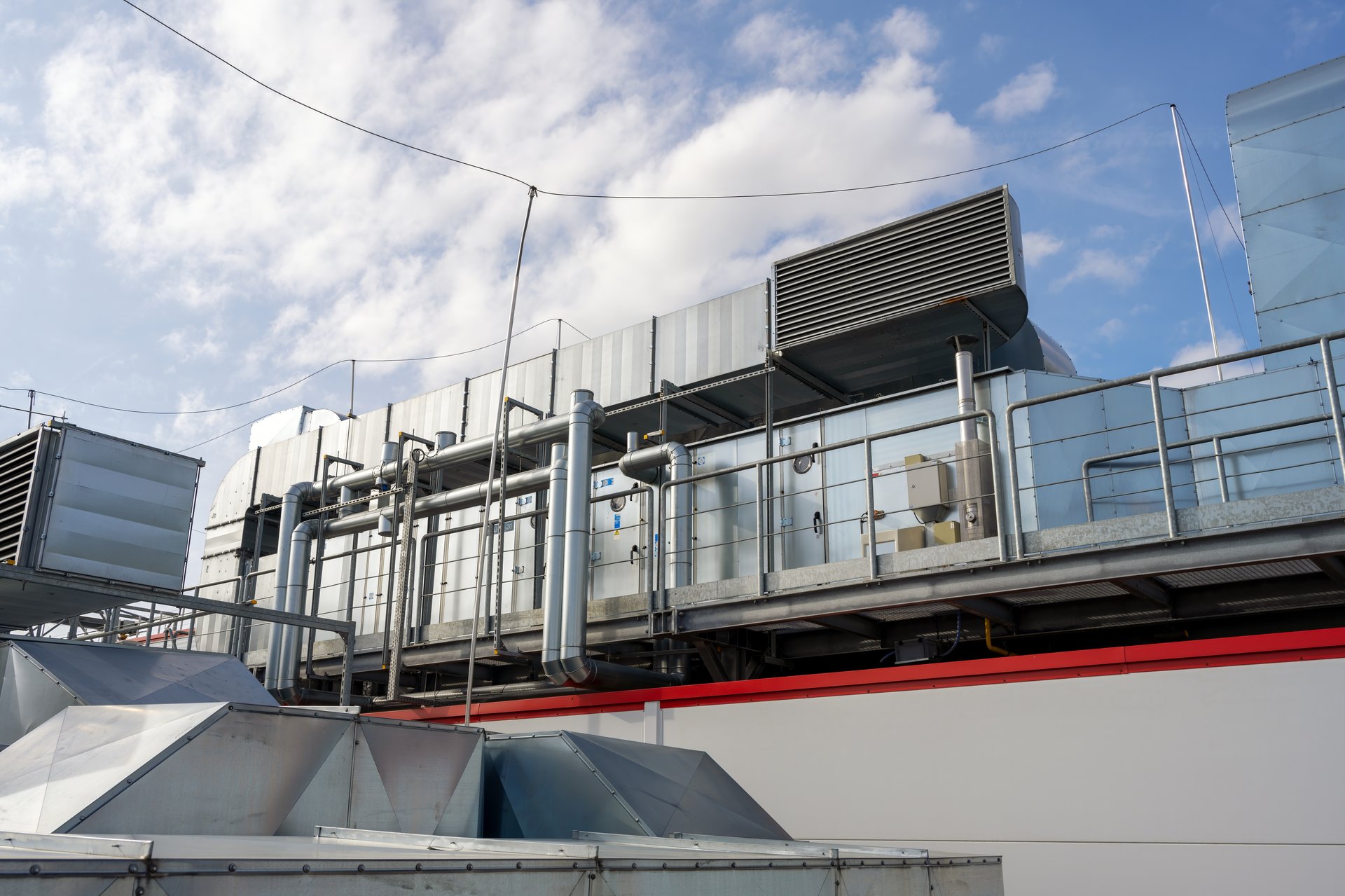 Ventilation ducting and air handling units on the roof of manufacturing plant wide angle view