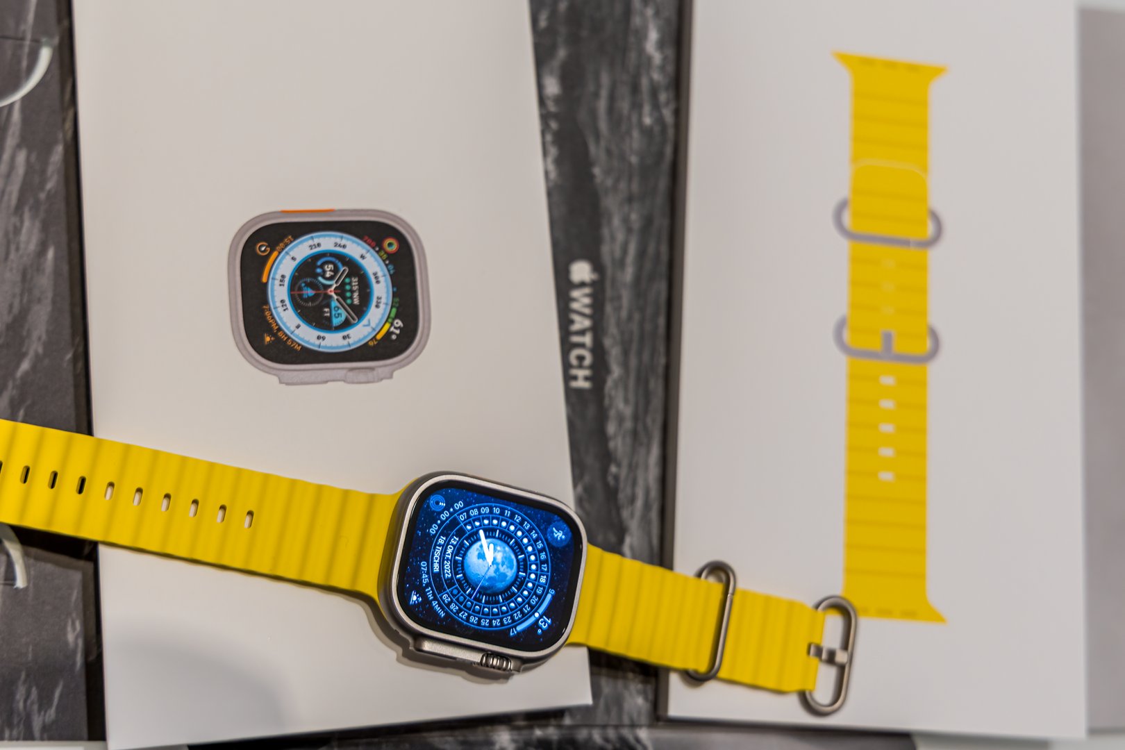 Frankfurt - Main, Germany - September 23rd 2022: A german photographer bought the new Apple Watch Ultra with the yellow Ocean band. Unboxed the watch and looked at the packing which fits to the topic of the band. In this case diving, divided in the watch itself and the band.