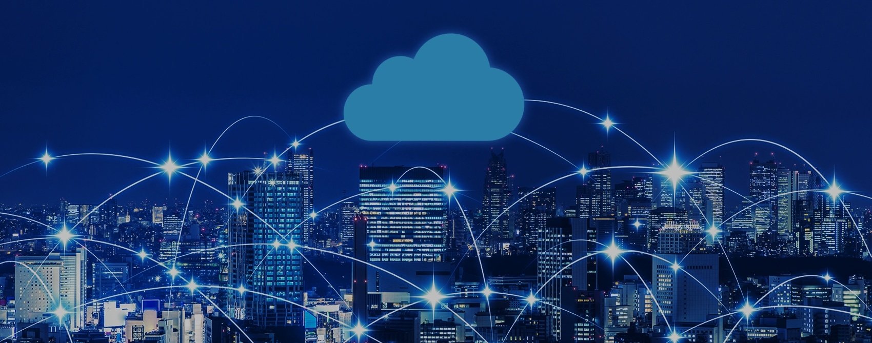 A city skyline at night with a large cloud symbol above, connected by bright lines symbolizing digital connectivity.