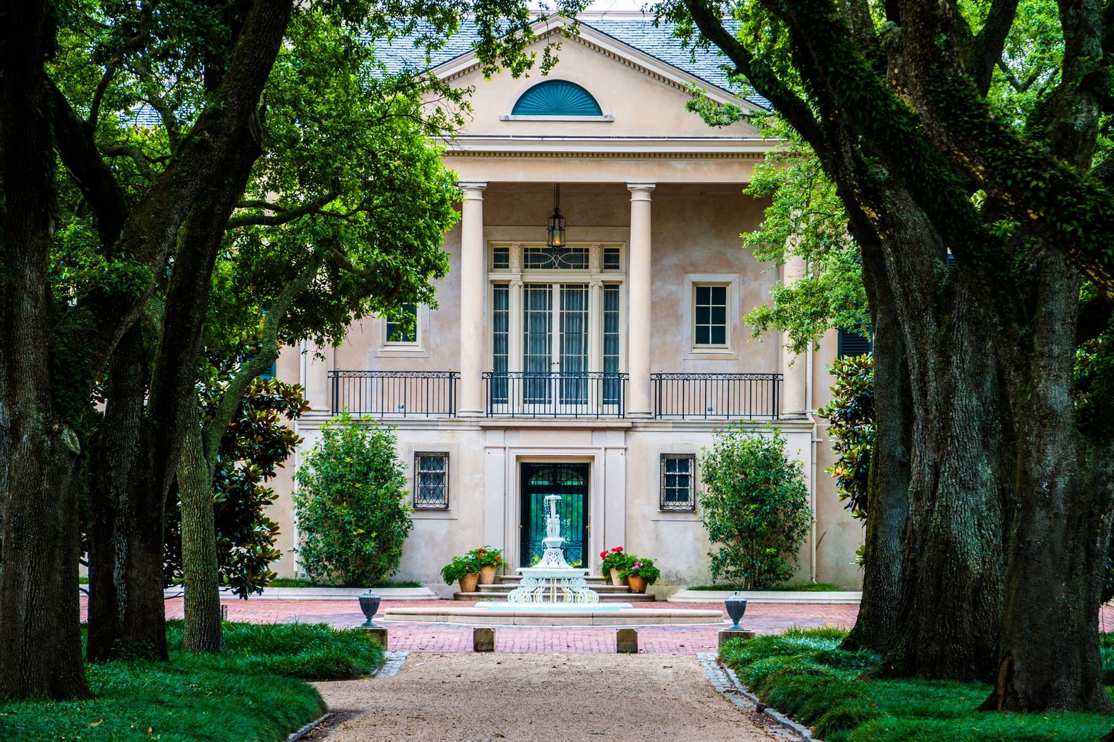 Looking Down The Live Oak Lined Driveway of A Historic New Orleans, Louisiana Plantation House
