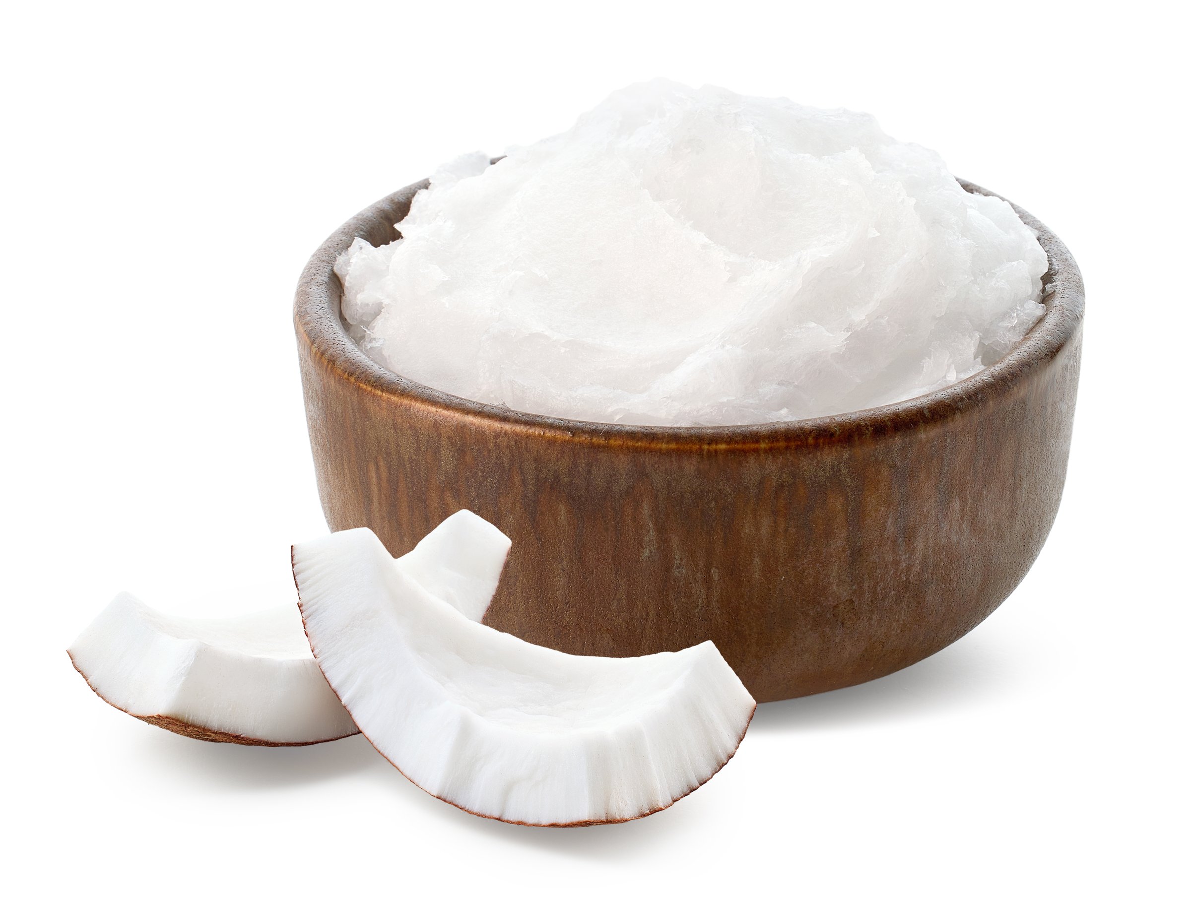 Brown ceramic bowl of coconut oil and fresh coconut pieces isolated on white background