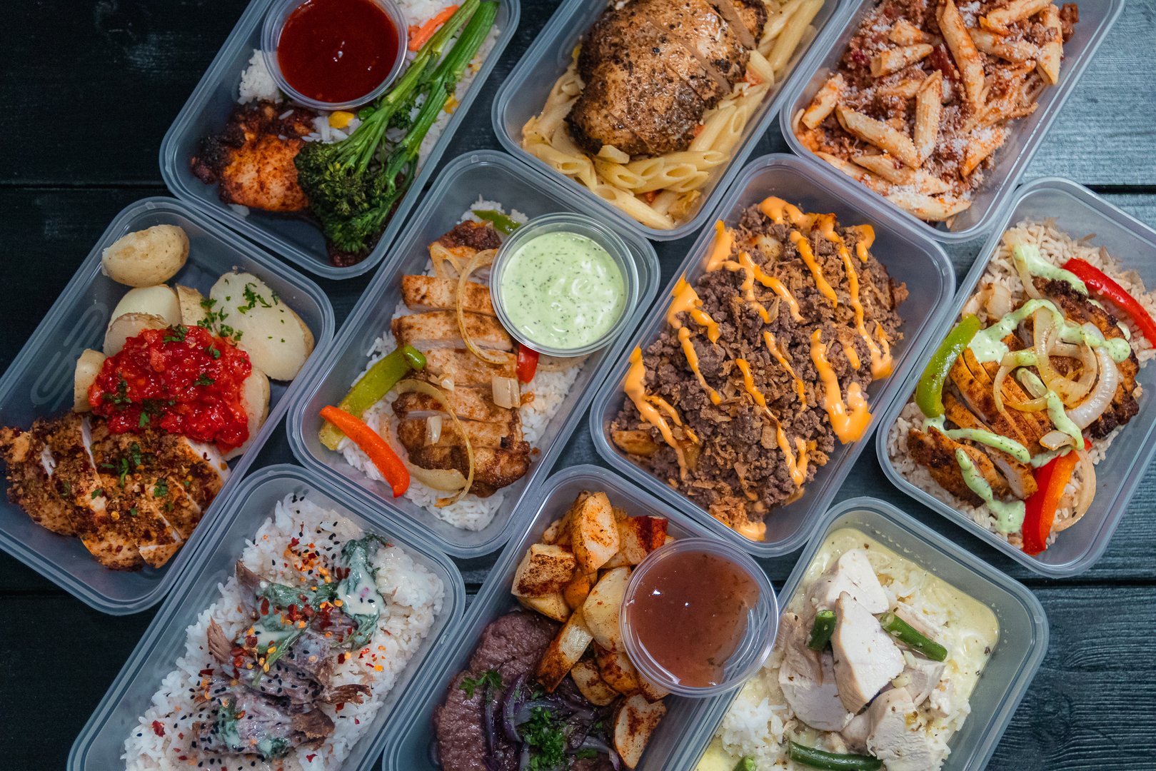 Meal Preparation Prep in Containers Laid out in a black background studio lighting variety