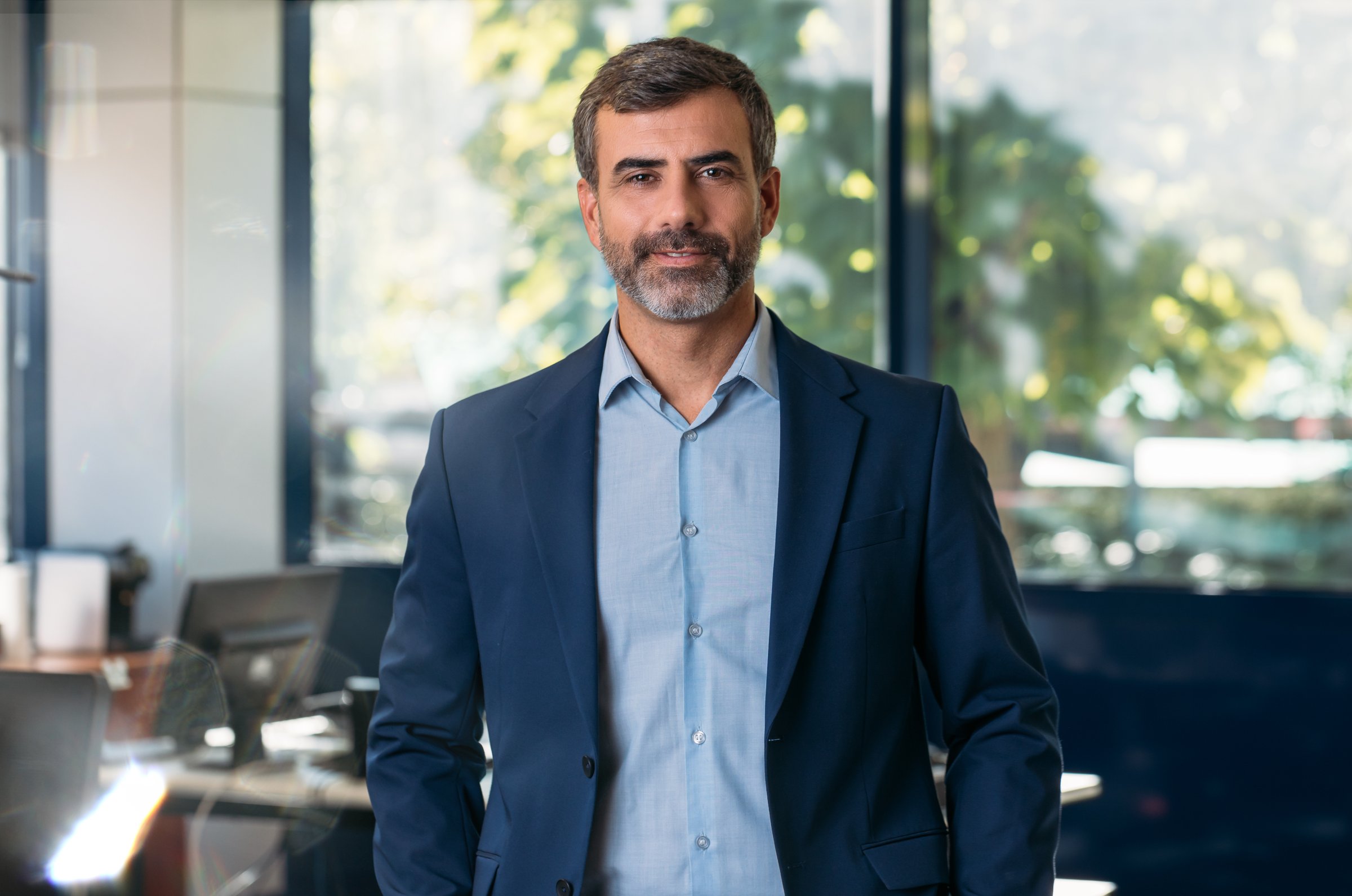 Portrait of businessman looking at camera in office