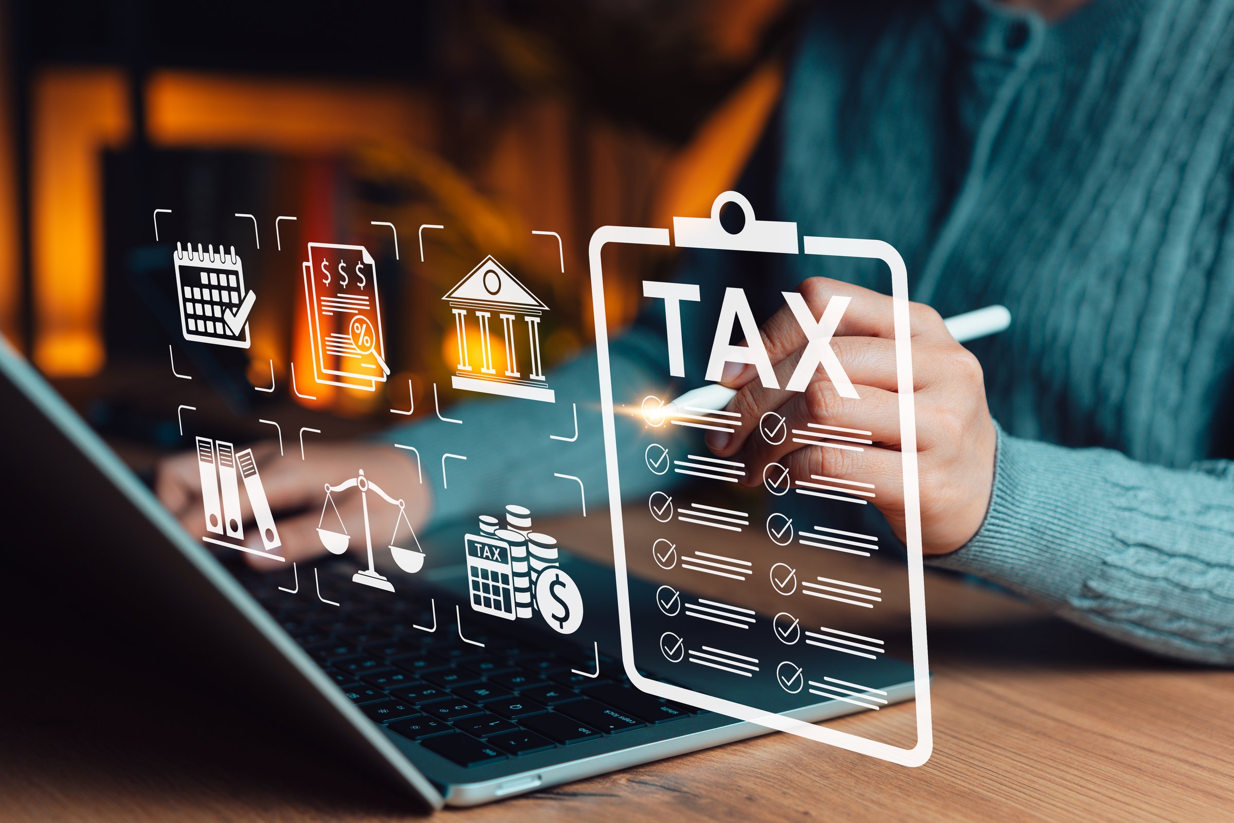 Tax Planning Concept. Person using laptop with digital icons tax documents, calendar, financial reports, law, regulation, compliance, monetary calculation, effective taxes management, taxation form,