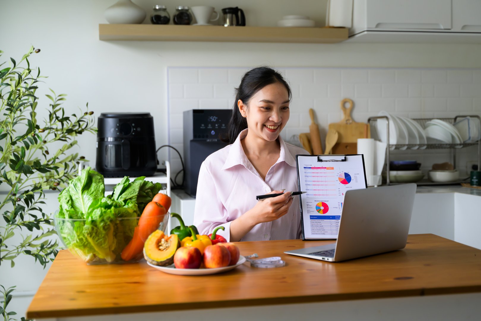 Woman nutritionist giving virtual advice on healthy eating, showing personalized diet plan graphs during online consultation