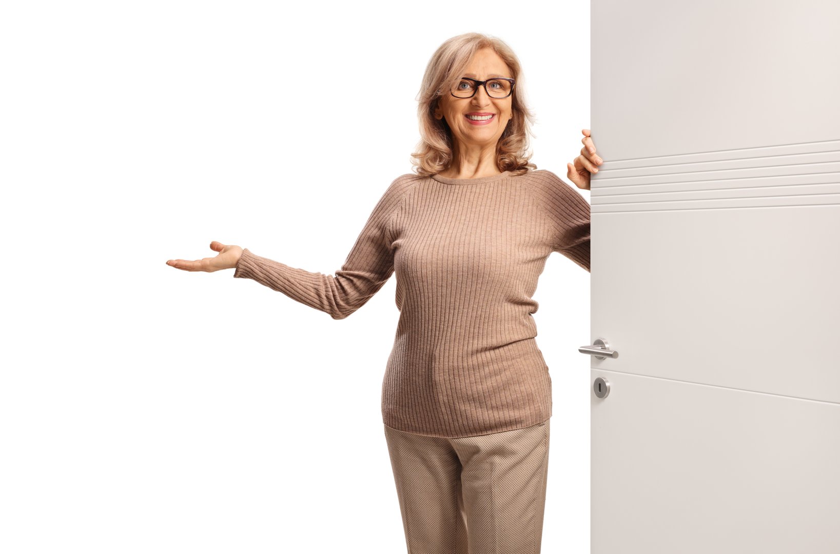 Woman opening a door and gesturing welcome isolated on white background