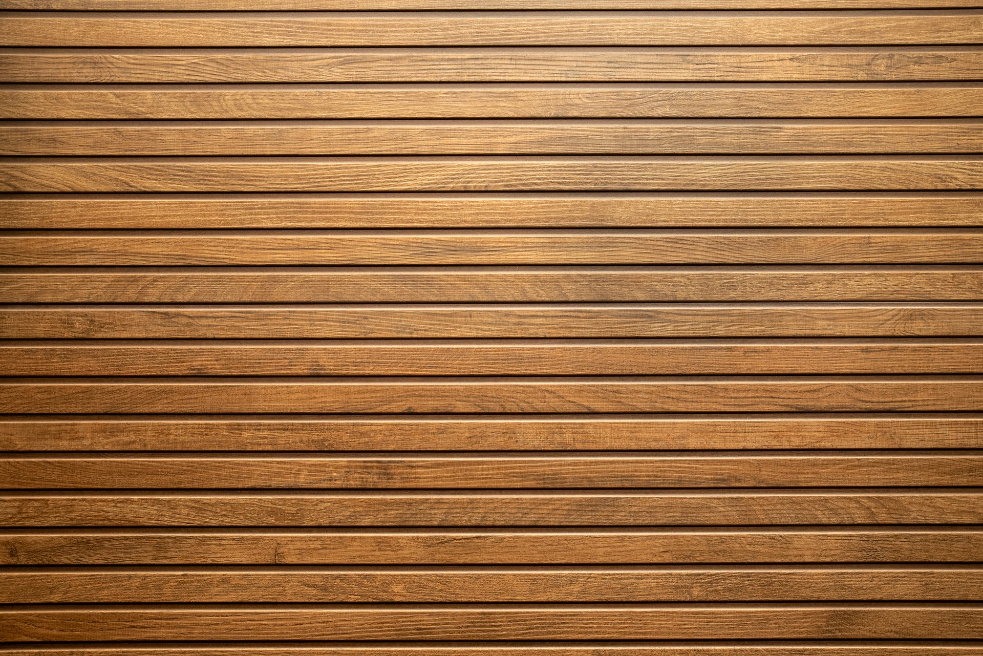 Ceramic wooden slatted panel with a natural texture and warm brown tones