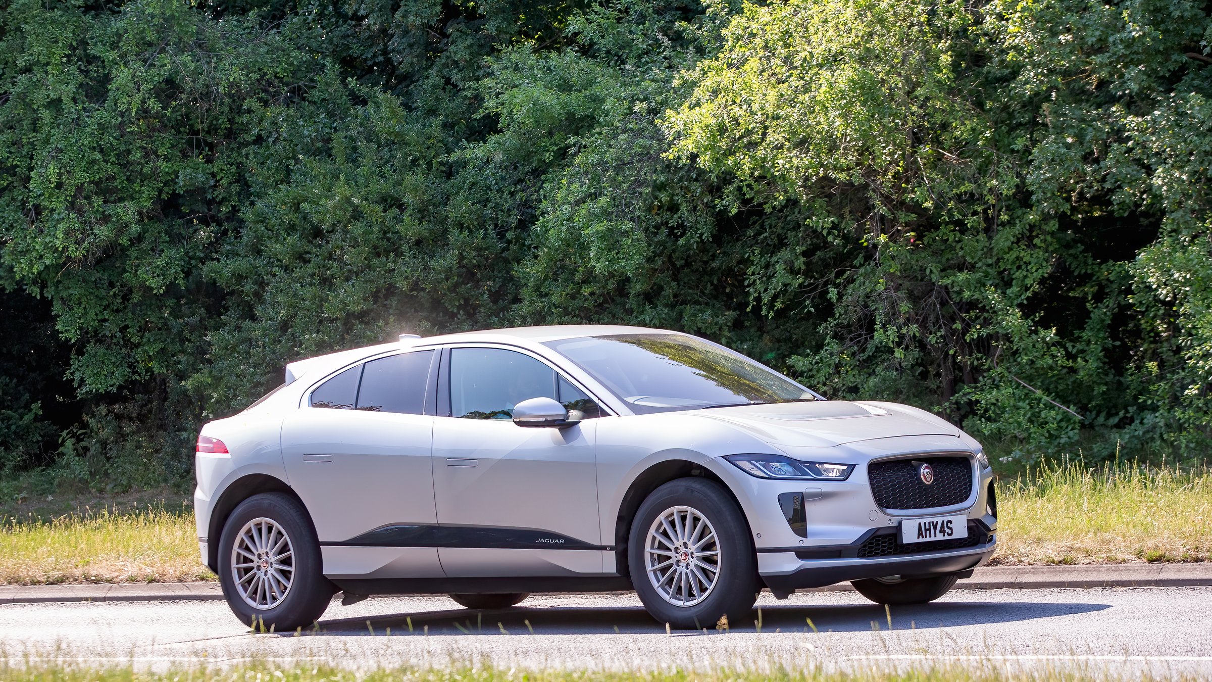 Milton Keynes,Bucks,UK - June 16th 2025:  2020 white Jaguar i-pace electric car driving on a British road