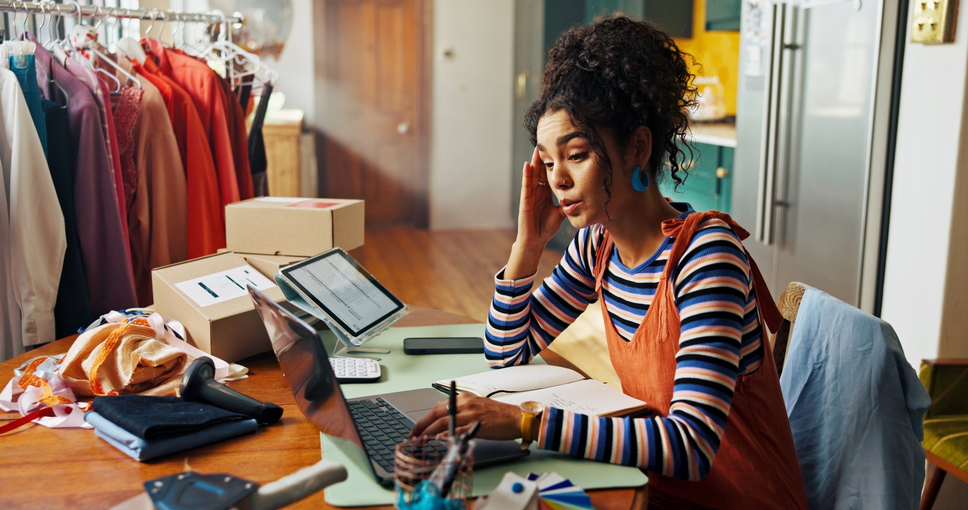 Headache, stress and woman on laptop for small business, lost order and package mistake of courier fail. Migraine, person and check online of logistics error, inventory management and delivery crisis