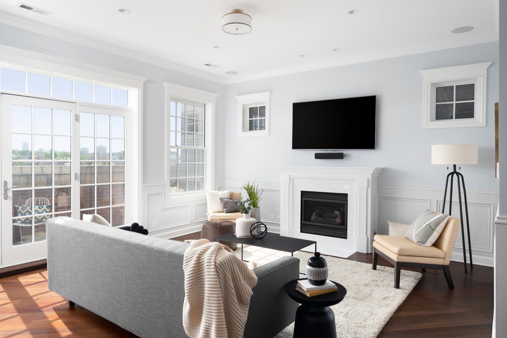 Living room TV mounted above fireplace with clean wire concealment