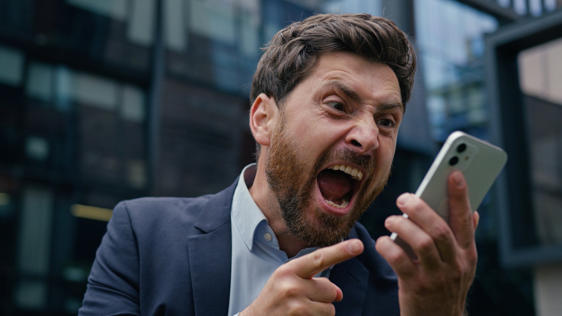 Annoyed mad crazy business man angry furious Caucasian businessman guy male boss employer aggressive irritated talk mobile phone shout scream yell cellphone conflict in city quarrel rage argue outdoor. High quality 4k footage