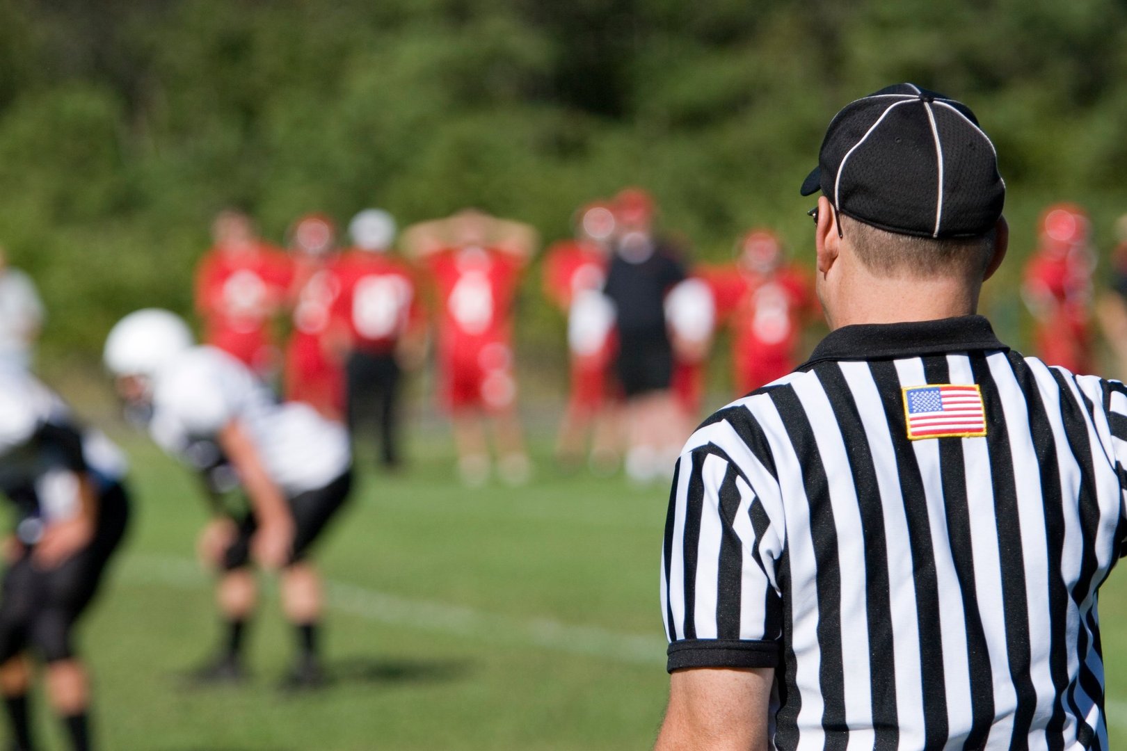Referee on sideline of American football game.