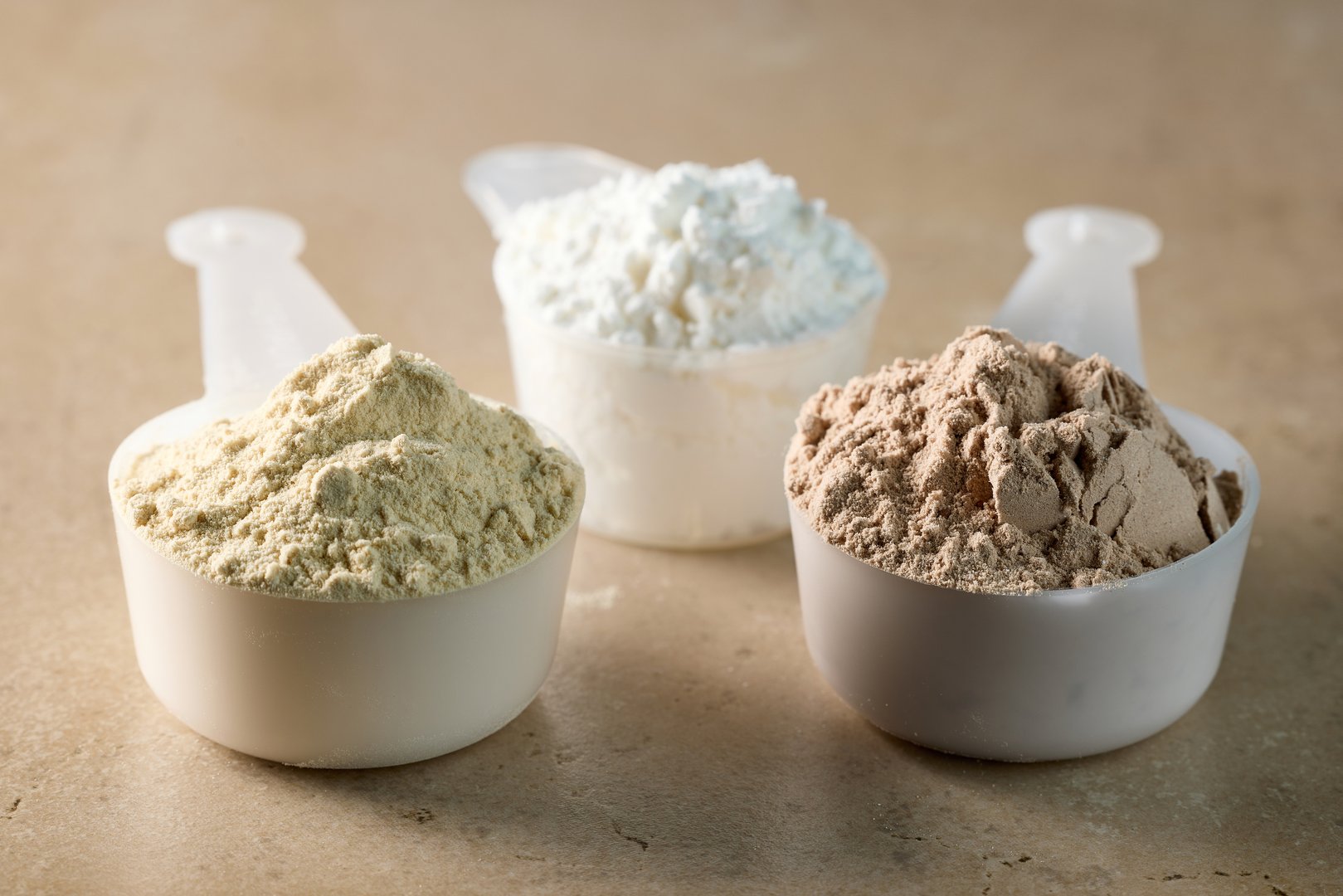 protein powder in scoops.  whey sports nutrition. dry mixture for preparation of sporting or dietary drink.