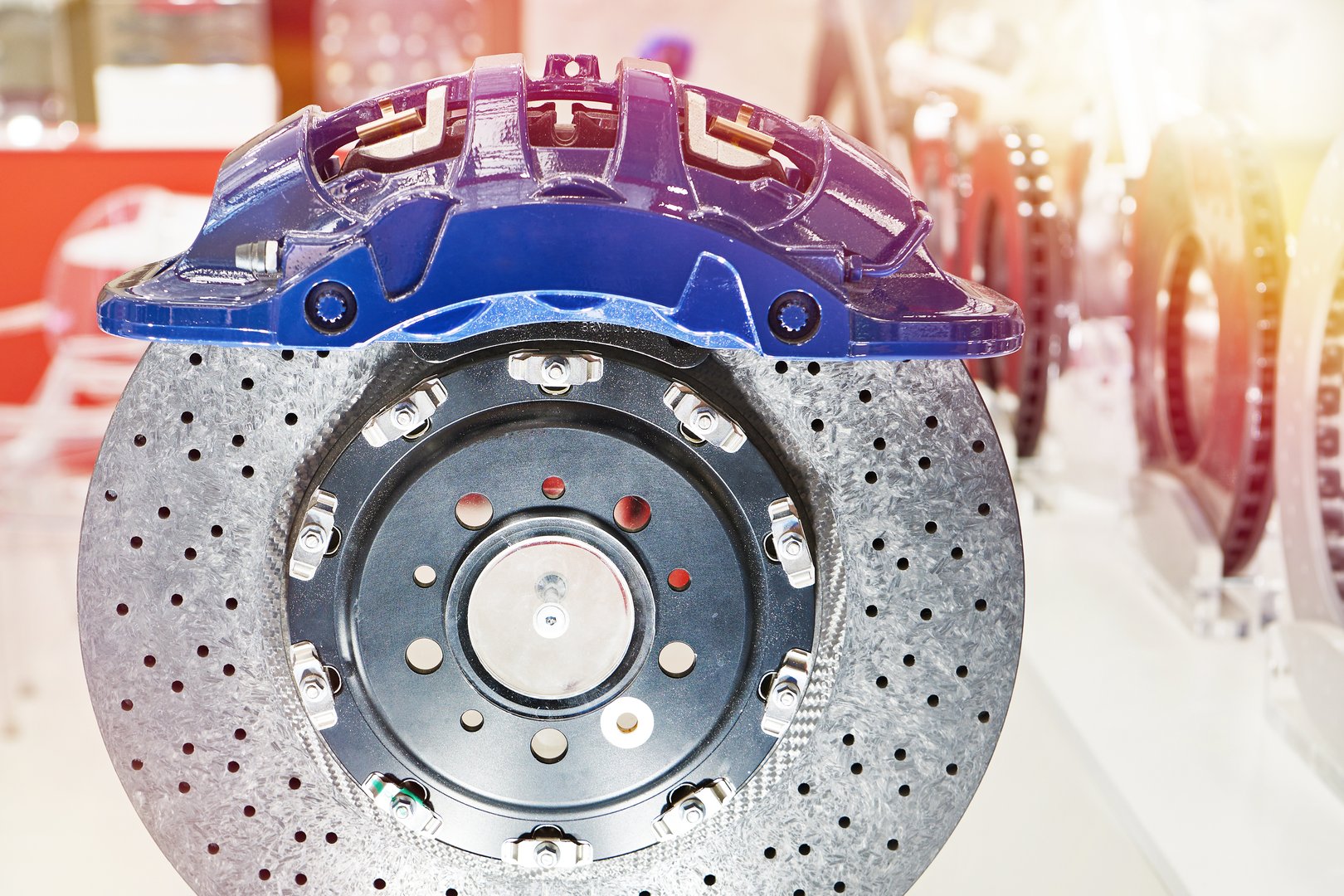 Front monoblock caliper and front brake disc