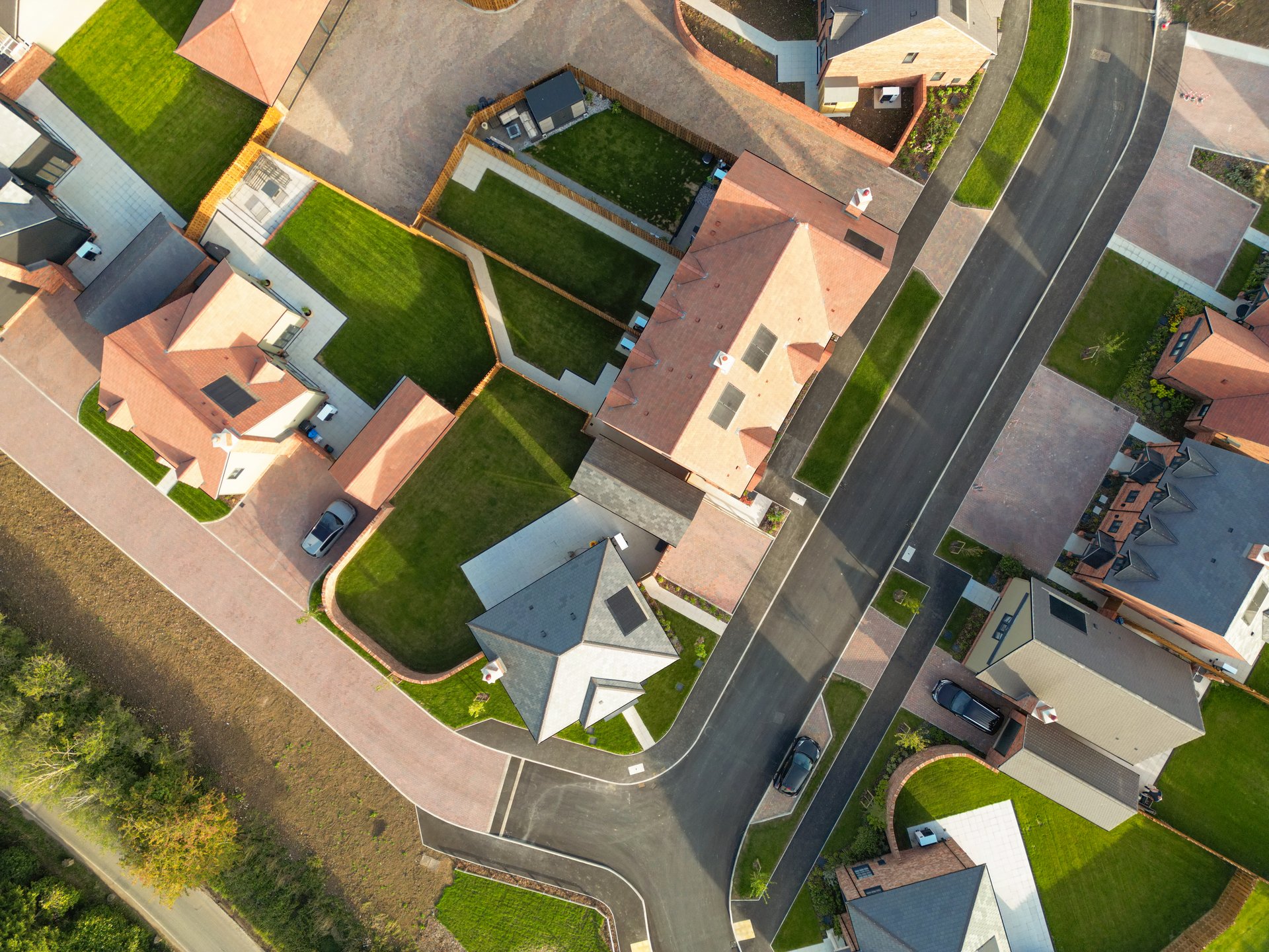 Drone top down view of a newly competed housing development, catering for both affordable, first time buyers and larger executive homes. Notice the newly laid, lush lawns.