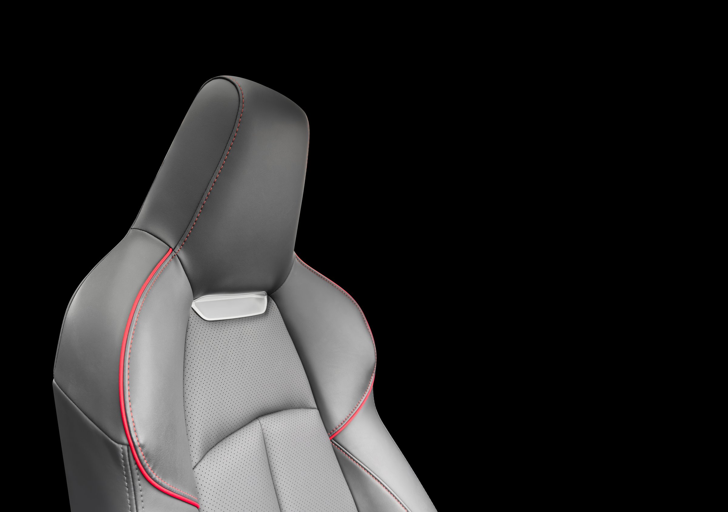 Car black leather interior. Part of leather car seat details with white stitching. Interior of prestige car. Perforated leather seats isolated on black background. Perforated leather.