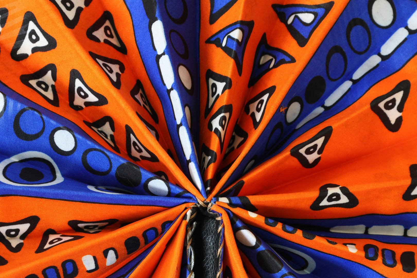 African Round fan with geometric pattern for backgrounds.