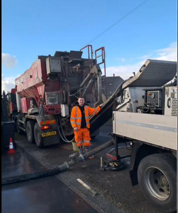 Female Civil Engineer Using a Laptop Computer and Talking with General Workers at a Residential Building Construction Area