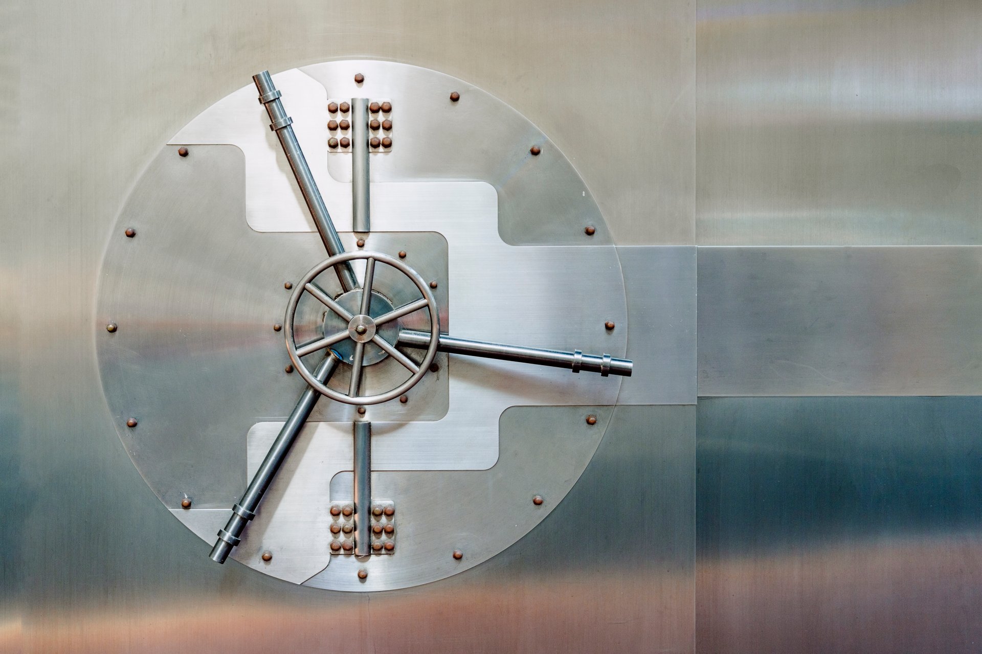 Round vault door with visible locking mechanism, symbolizing banking security and protection of valuables