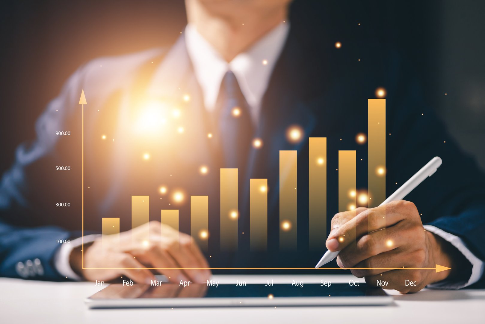 Golden bar chart with businessman analyzing financial data using digital pen. Concept of growth, investment, success, and corporate strategy in modern business.