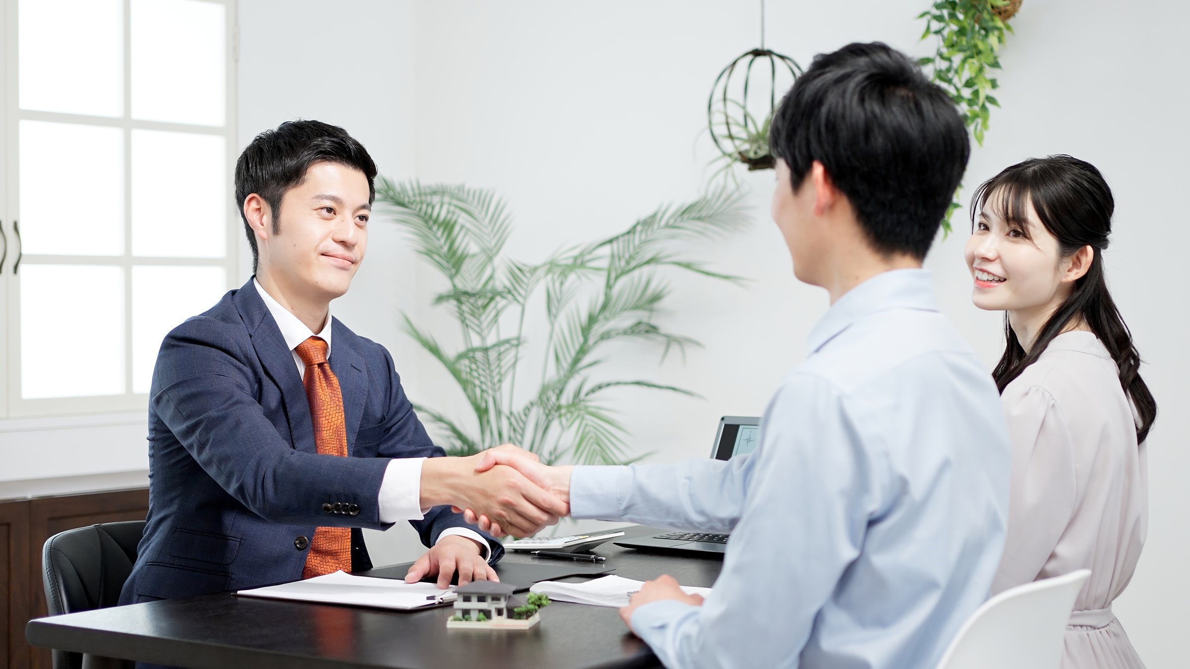 Men shaking hands during a real estate deal