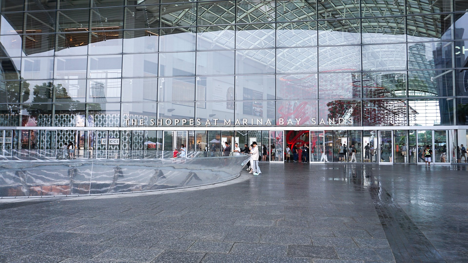 Singapore - January 22, 2025: Tourists standing near Fountain Funnel Singapore near Shoppes Marina Bay Sands at Singapore on January 22, 2025. It is famous shopping mall at Marina Bay at Singapore