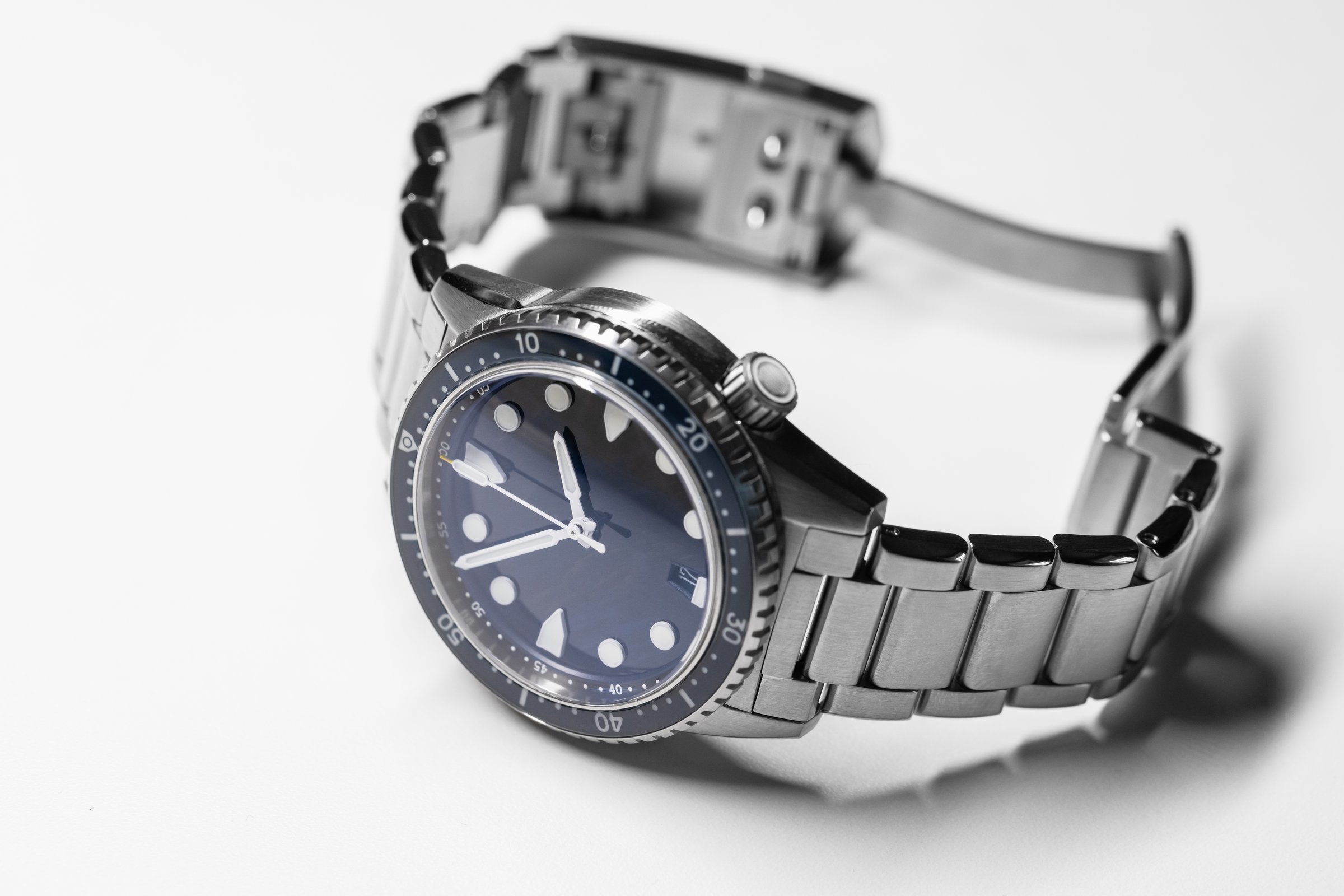 Elegant stainless steel dive watch featuring a blue dial, sapphire glass and luminous markers, styled with a sturdy bracelet, exuding sophistication, functionality, and timeless design