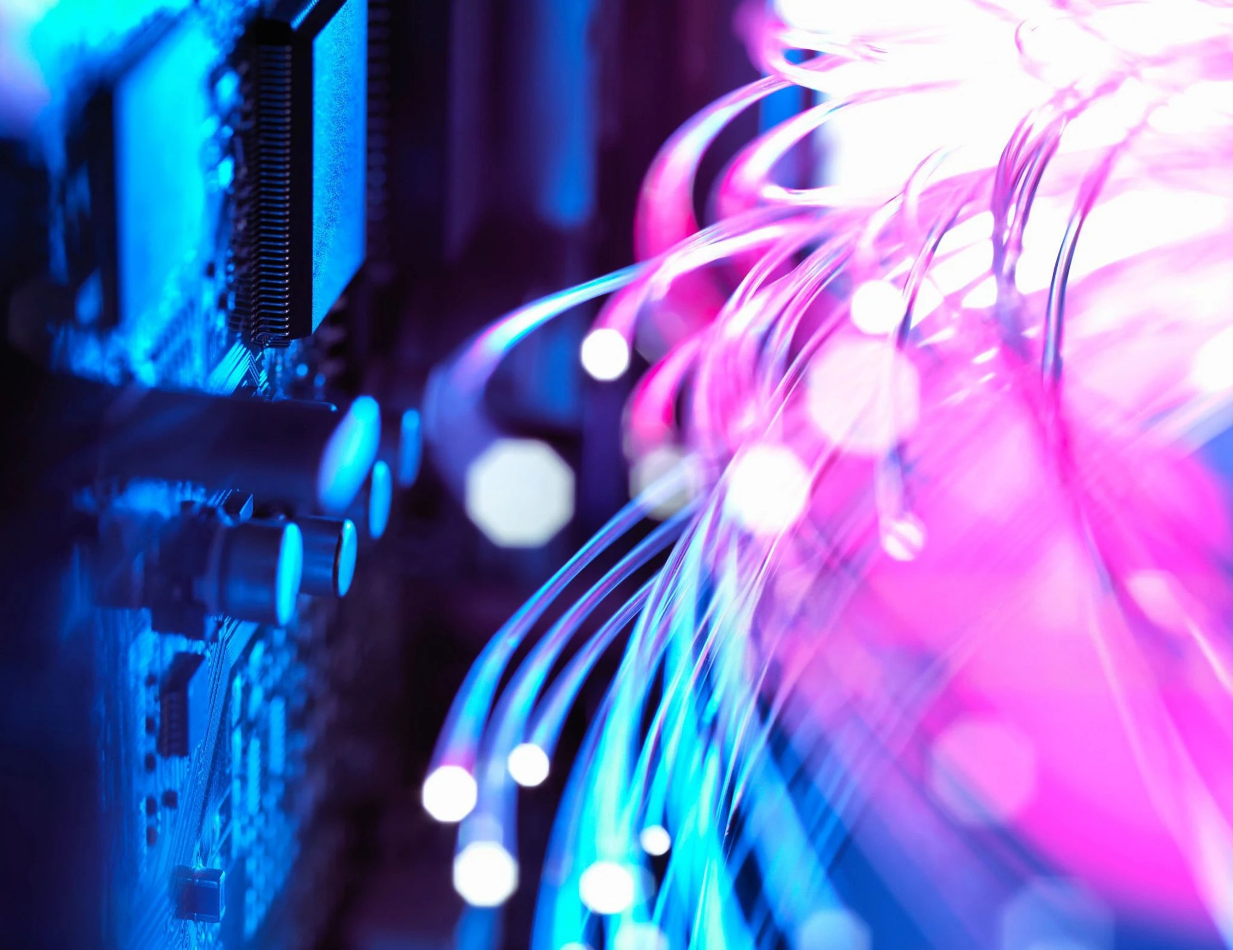 A close-up view of fiber optic cables with bokeh effect, representing modern communication technology.
