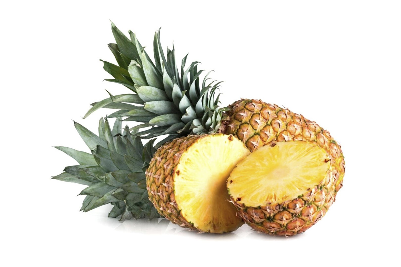 Whole pineapple with crown and a cut half exposing juicy yellow interior, isolated on white background.