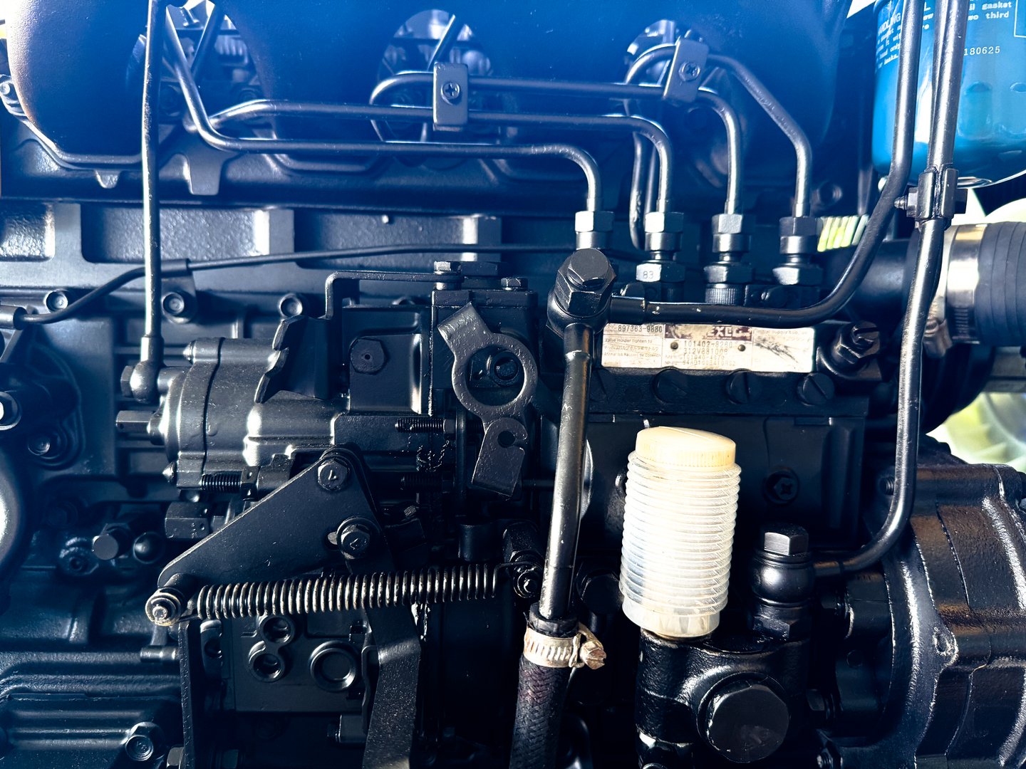 Close up detail of a powerful diesel engine, showcasing intricate mechanical components, fuel lines, and industrial machinery parts for heavy equipment and engineering technology.