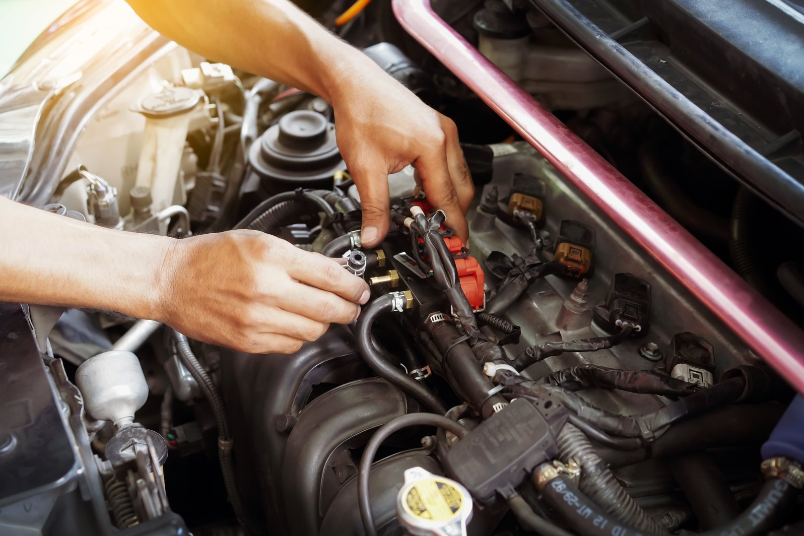 Hands man auto mechanic tuner LPG system of car engine on car engine background for maintenance or repair service concept.Close up.