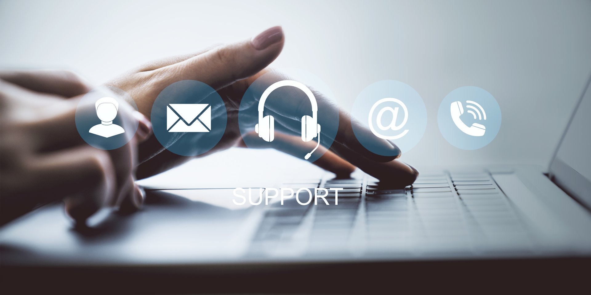 Woman's hands typing on laptop keyboard with transparent support icons overlayed on a blurred background, concept of online help service