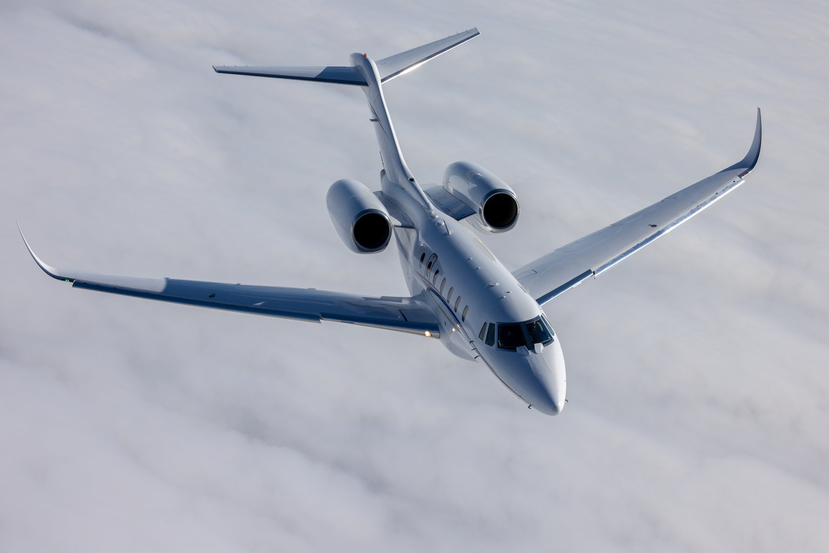 Top view of a Citation X (business jet) over  cloud layers