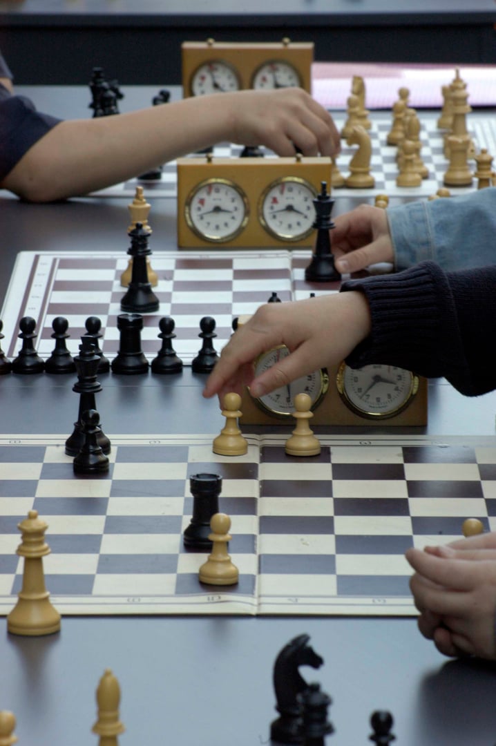 playing a game of chess, a strategic board game for two players