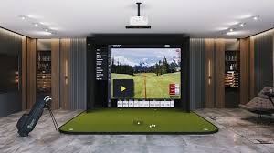 Indoor golf simulator setup with a large screen displaying a golf course, a green putting area, and a golf bag next to it.