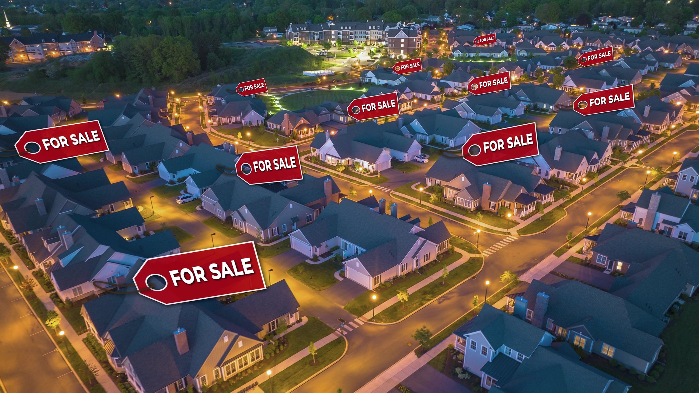 For sale icons over American suburban houses at night. Modern USA Real estate market. Neighborhood lit by streetlights. Aerial