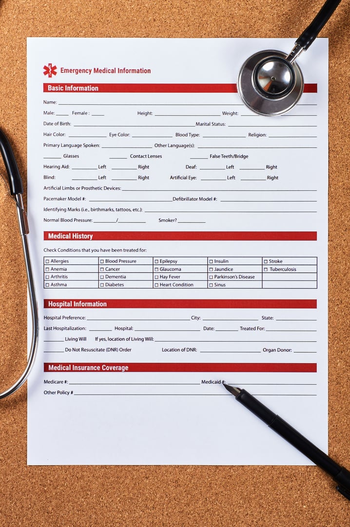 Emergency medical information form, stethoscope and pen on corkwood background. Flat lay.