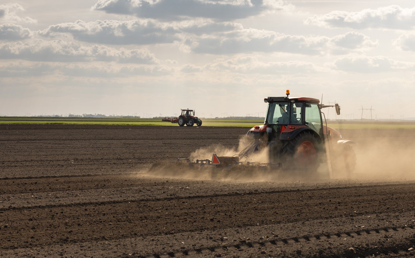 Farmer preparing his field in a tractor ready for spring.