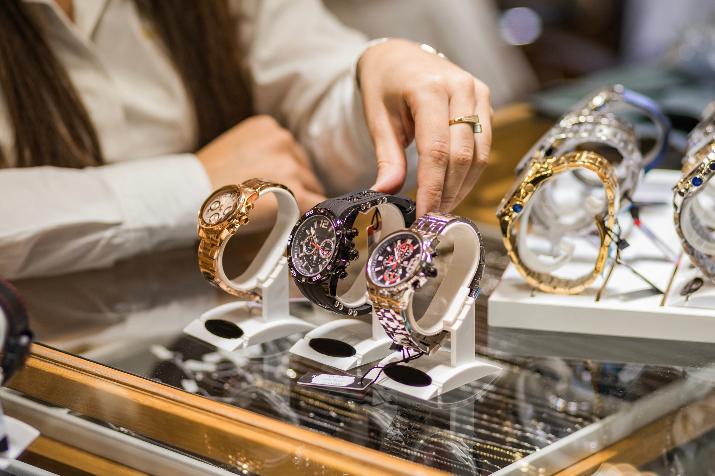 Close-up of elegant wristwatches on display in a jewelry store, showcasing luxury and style. Perfect for fashion enthusiasts and collectors seeking timeless beauty.