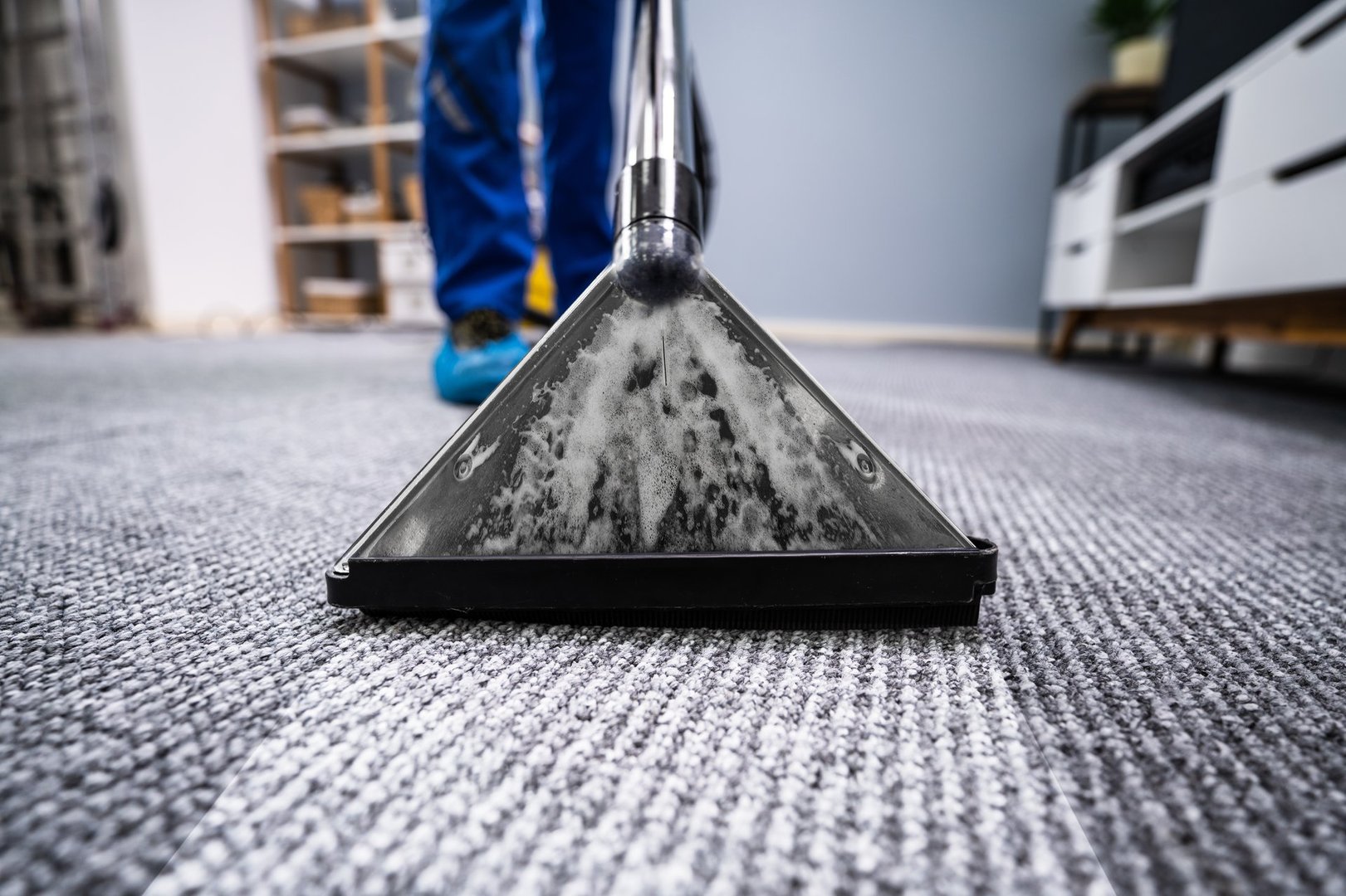 Close-up Of A Cleaning Carpet With Vacuum Cleaner