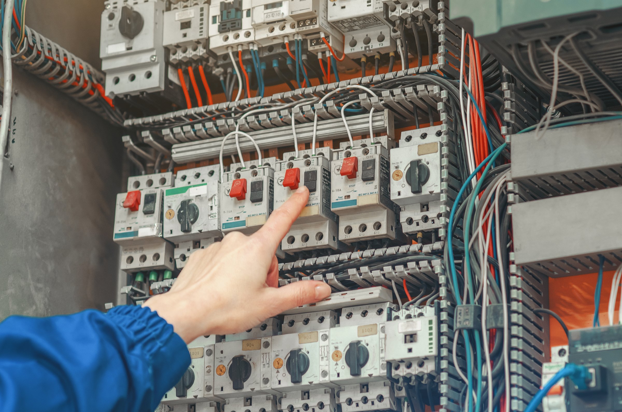 Electrician working on circuit breaker