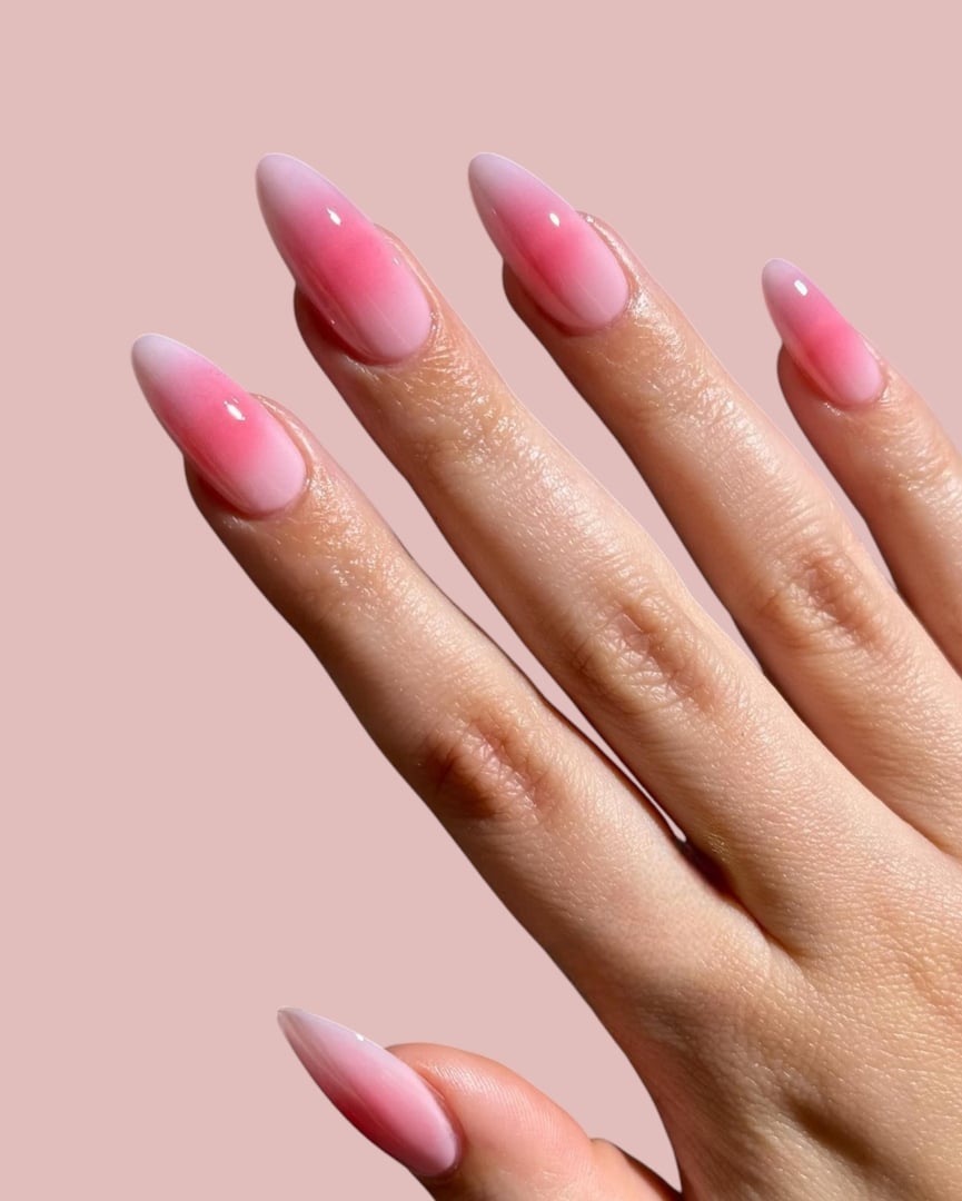 Hands and fingers of a young woman with simple, modern, elegant manicure with a light background, nail art