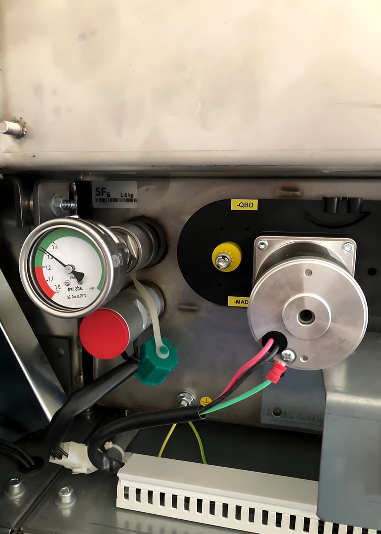 The perspective of circuit breaker compartment of medium voltage GIS Switchgear such as SF6 pressure gauge, closing and tripping coil.
