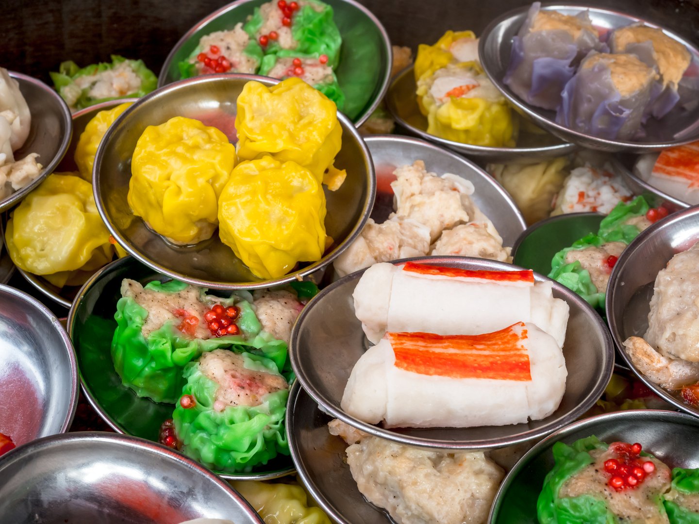 Various traditional food Chinese dim sum in mini bowls in steamer, preparing in local restaurant, top view. Close-up Chinese dim sum takeaway finger food. Tasty Asian breakfast background.
