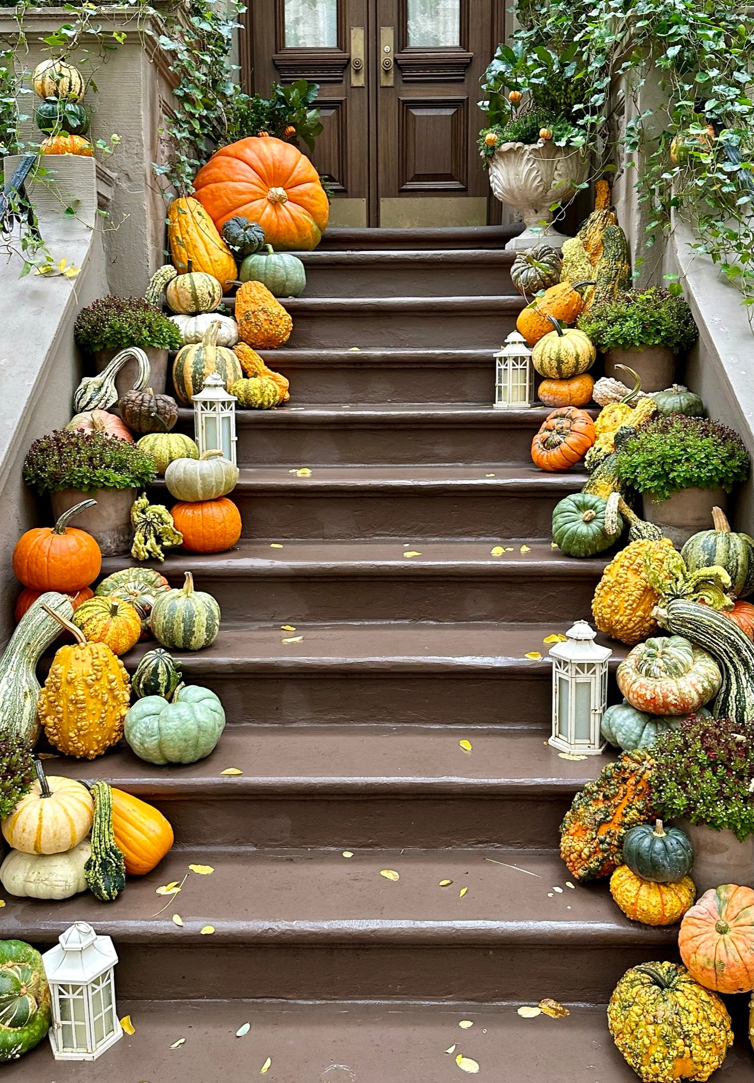 In the fall season in New York City, the steps of a classic Upper West Side brownstone become a picturesque display, adorned with an array of pumpkins and gourds in various shapes and shades. This quintessentially autumnal scene, set against the historic charm of the brownstone, offers a warm, inviting glimpse into the city's seasonal celebration, blending urban living with the rustic beauty of fall harvests.
