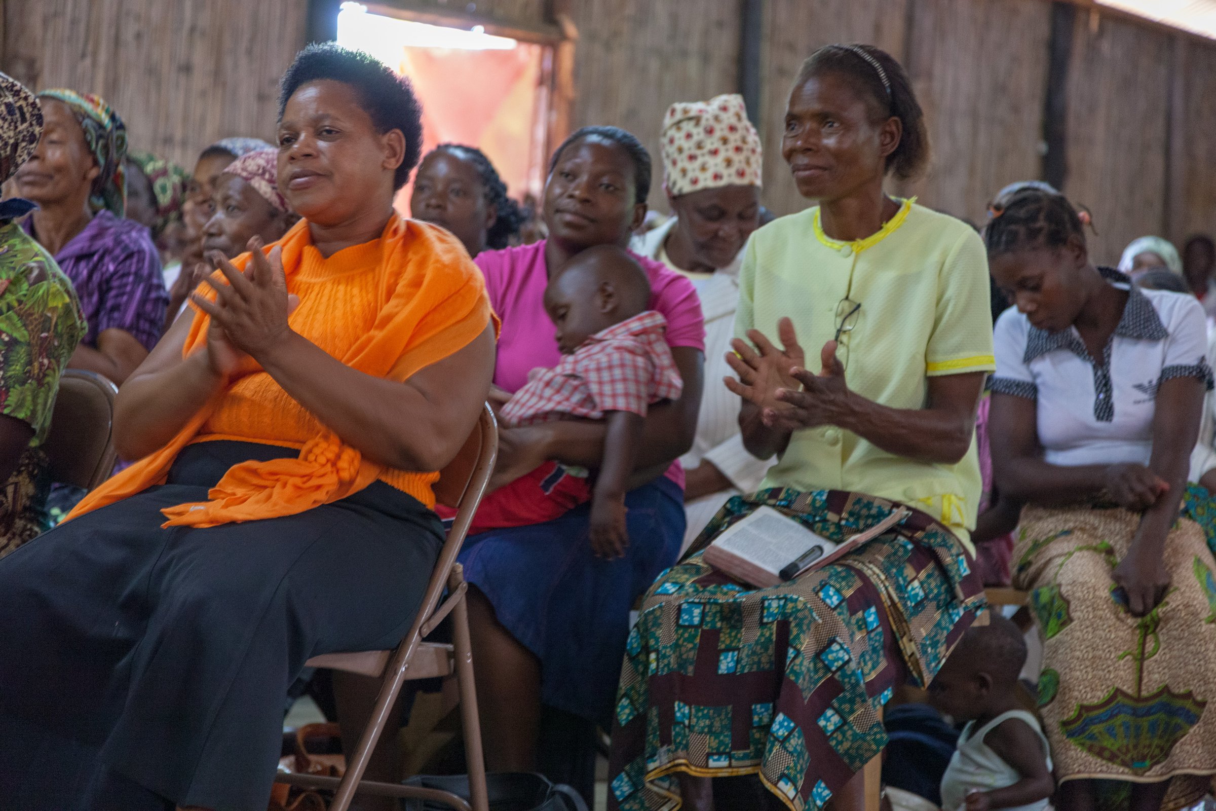 Close up front view of unidentified African congregation in Pentecostal Christian Sunday church service
